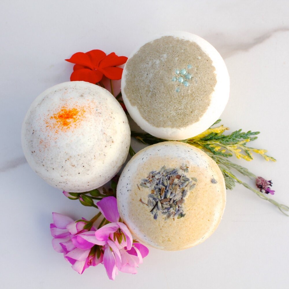 set of 3 bath bombs on a couple of flowers