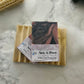 pink nd swirls of black soap bar named sex a peel on a wood soap saver 