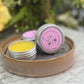 solid perfume tins displayed to show texture of a smooth balm