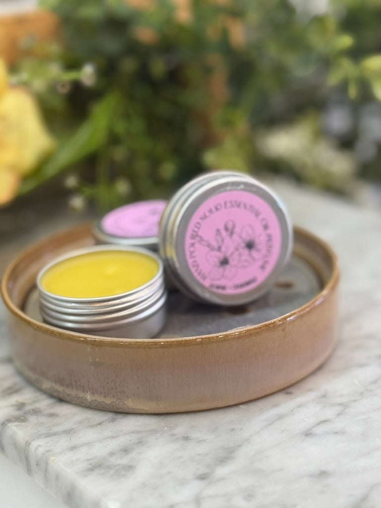 solid perfume tins displayed to show texture of a smooth balm