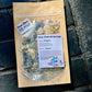 A craft zip bag containing dried herbs for a facial steam insert, labeled with 'Calming Facial Steam Instructions' and the brand name 'Good Common Sense Naturals'.