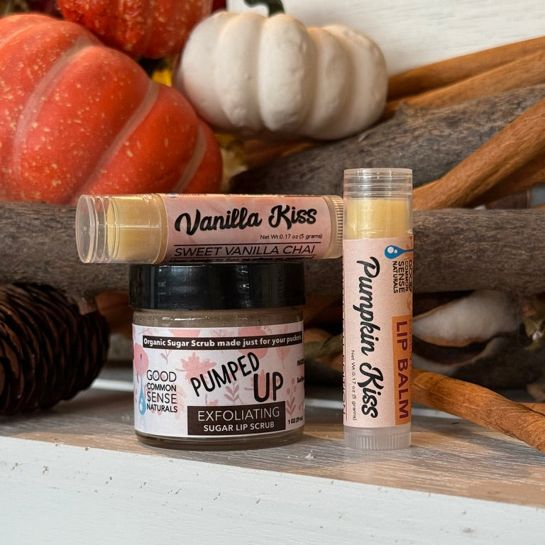 Pumped Up Lip Care Kit gift set featuring the Pumped Up Exfoliating Sugar Lip Scrub and Vanilla Kiss and Pumpkin Kiss lip balms, styled with fall décor, Good Common Sense Naturals