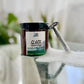 A jar of Close Shave Cream with a label showing the brand and product name, placed on a glass table 