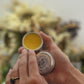 open solid perfume tin to show smooth balm surface