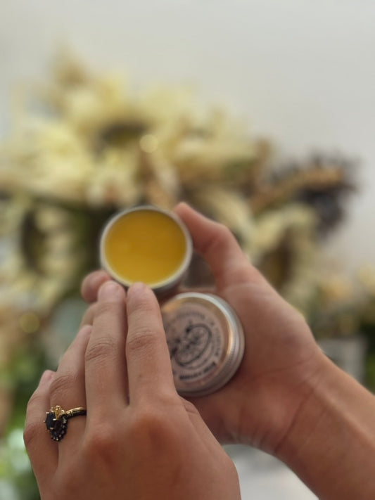 open solid perfume tin to show smooth balm surface
