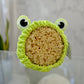 A headband designed to look like a frog with a green color and a textured surface, with eyes surrounding a large sea sponge. 
