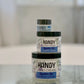 Three jars of Handy Cream hand cream in varying sizes, stacked together on a surface, with the product name visible on each jar.