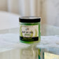 clear jar filled with a green scrub labeled Buff my soul. on glass table 