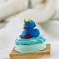 blue bath bomb topped with blue body butter and a blue rubber ducky 