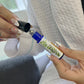 girl displaying a roller bottle with the label Tension