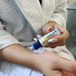 women rolling on an immunity essential oil bottle 
