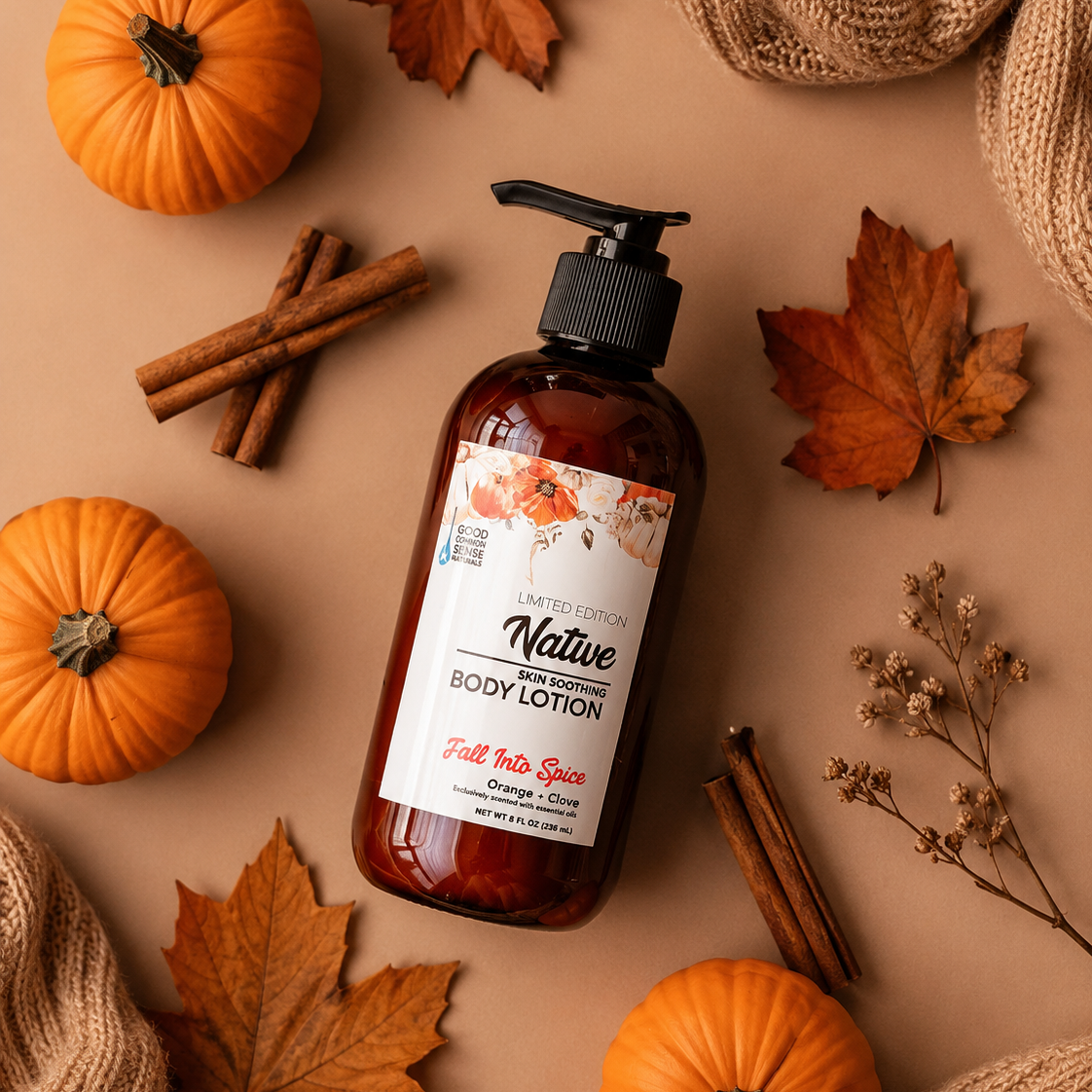A bottle of Native Earth Body Lotion in 'Fall Into Spa' scense, styled in a flat lay with autumn props including mini pumpkins, maple leaves, cinnamon sticks, and burlap on a warm beige background.