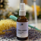 Bottle of herbal hydro spray with lavender on a marble surface