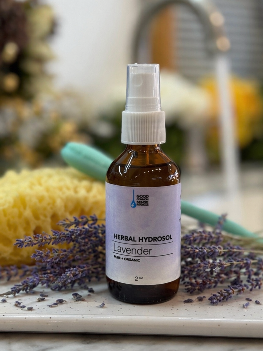 Bottle of herbal hydro spray with lavender on a marble surface
