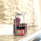 A gift set containing various lip balms and treatments, presented in a clear container with a decorative bow on top, labeled with the brand 'Beet It'.