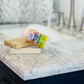 Orange you happy Bubble Push Pop on a wooden soap saver with a sink in background 