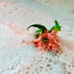 green small toy dragon surrounded by bubbles 