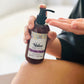 A pump bottle of Native Body Lotion - Lavender Plains with a label showing the product name and a brief description, held in a person's hand.