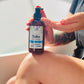 women holding the native body lotion on her knee pumping into her hand. 
