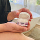 girl holding a mini oh my buttah jar 