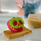 Sleeping Death Halloween bath bomb shaped like an apple, topped with green coconut oil frosting, Good Common Sense Naturals