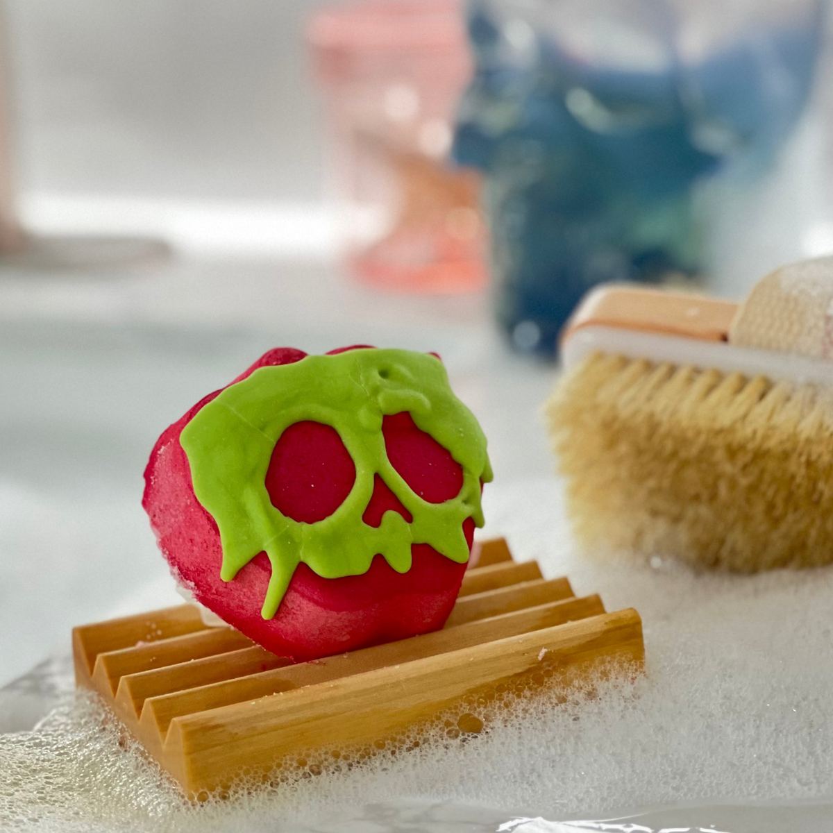 Sleeping Death Halloween bath bomb shaped like an apple, topped with green coconut oil frosting, Good Common Sense Naturals