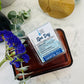 wax melts labeled in a clear container with plants surrounding 
