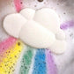 A bath bomb designed to look like a fluffy cloud with a rainbow effect when added to water.