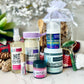 collection of face care with Not any pore facial toner, Fairest of Them All 3.4 oz, Swampthing Mud Mask 8.5 oz, Camouflage Cleansing Grains, Lipstick, Single sided Jade roller, Lip Scrub. on a marbel counter 