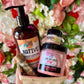 A gift set containing Native Body Lotion, Buff My Soul Sugar Scrub, hand cream, and lip balm, placed in a basket with floral background.