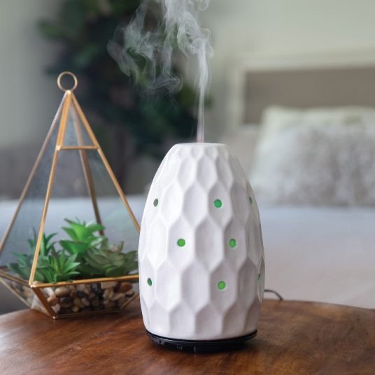 white hexagon diffuser, placed on a kitchen countertop, emitting a vapor.