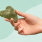hand holding a green Jade Massager