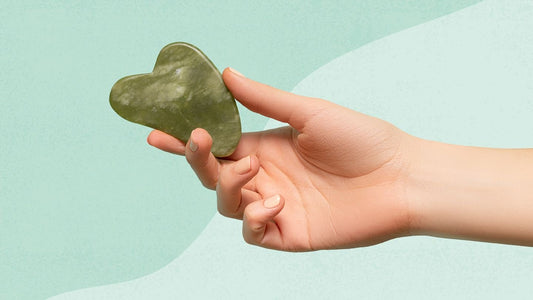 hand holding a green Jade Massager